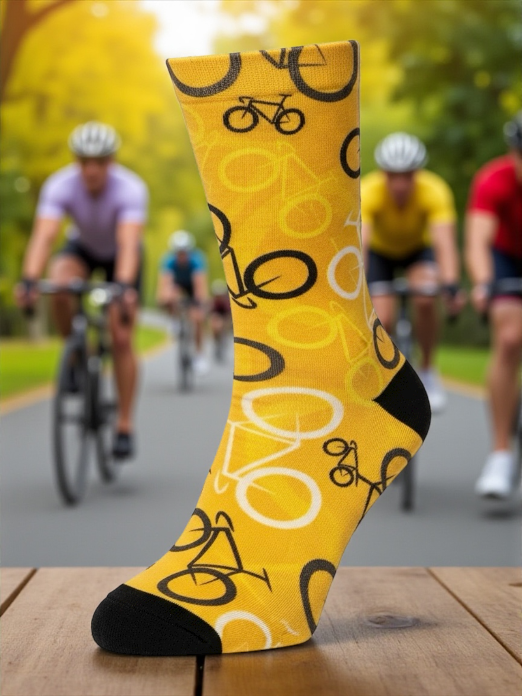 Yellow sock with bicycle pattern in front of a blurred background of cyclists